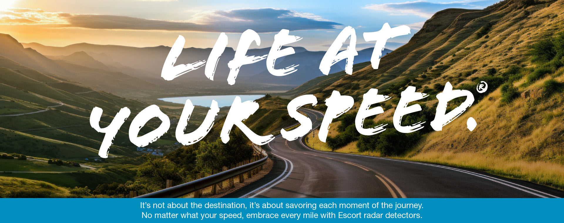 Life at your speed text over road through mountains